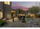 Inviting backyard with a covered patio, a grill, and serene landscaping, perfect for entertaining at 40807 N Barnum Way, Anthem, AZ 85086