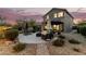 Spacious backyard featuring multiple seating areas, a fire pit, and lush landscaping at 40807 N Barnum Way, Anthem, AZ 85086