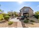Large backyard with a patio, seating areas, and well-maintained landscaping under a sunny sky at 40807 N Barnum Way, Anthem, AZ 85086
