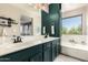 Beautiful bathroom featuring a double vanity with modern fixtures and a soaking tub with a large window at 40807 N Barnum Way, Anthem, AZ 85086