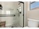 Bright bathroom features a glass shower with a rain shower head, bench, and elegant hexagon tile flooring at 40807 N Barnum Way, Anthem, AZ 85086