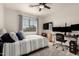 This bedroom features a large window, a ceiling fan, neutral tones, and is complete with a desk at 40807 N Barnum Way, Anthem, AZ 85086