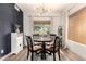 Cozy dining area featuring modern chandelier lighting, a round wooden table, and views to the outdoors at 40807 N Barnum Way, Anthem, AZ 85086