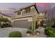Charming two-story home with a desert landscaped front yard, attached two car garage and a tile roof at 40807 N Barnum Way, Anthem, AZ 85086