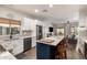 Spacious kitchen with marble counters, a large island, seating, and direct access to the living room at 40807 N Barnum Way, Anthem, AZ 85086