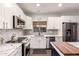 Contemporary kitchen with stainless steel appliances, marble countertops, and white cabinetry at 40807 N Barnum Way, Anthem, AZ 85086