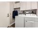 This laundry room features a washer and dryer, with extra storage and decor at 40807 N Barnum Way, Anthem, AZ 85086