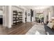 Open concept living room and dining room with wood floors, modern decor, and lots of natural light at 40807 N Barnum Way, Anthem, AZ 85086
