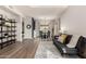 Open concept living room and dining room with wood floors, modern decor, and lots of natural light at 40807 N Barnum Way, Anthem, AZ 85086