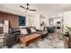 Spacious living room with a leather couch and an open layout view of the kitchen and dining spaces at 40807 N Barnum Way, Anthem, AZ 85086