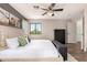 Inviting main bedroom showcases a large bed, neutral tones, a ceiling fan, and ensuite access at 40807 N Barnum Way, Anthem, AZ 85086