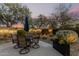 Outdoor dining area with seating for four, surrounded by lush landscaping and decorative plants at 40807 N Barnum Way, Anthem, AZ 85086