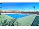 Bright blue tennis courts surrounded by desert landscaping with scenic mountain views at 40807 N Barnum Way, Anthem, AZ 85086