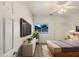 Modern bedroom with neutral-toned walls, ceiling fan, and a sliding door closet at 41344 W Laramie Rd, Maricopa, AZ 85138