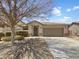 Charming single-story home featuring a two-car garage and low maintenance desert landscaping at 41344 W Laramie Rd, Maricopa, AZ 85138