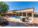 Beautiful backyard pool area with a stone waterfall feature, ample seating, and desert landscaping at 4321 E Morenci Rd, San Tan Valley, AZ 85143