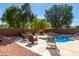 Backyard pool with lounge chairs and lush landscaping, perfect for relaxation and entertainment at 4321 E Morenci Rd, San Tan Valley, AZ 85143