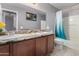 Bright bathroom featuring dual sinks, a large mirror, shower-tub combo, and updated fixtures at 4321 E Morenci Rd, San Tan Valley, AZ 85143
