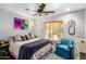 Comfortable bedroom featuring a Queen bed, large window, eclectic art and stylish furnishings at 4321 E Morenci Rd, San Tan Valley, AZ 85143