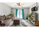 Inviting living room with cozy seating, ceiling fan, and stylish rug, filled with natural light from the French doors at 4321 E Morenci Rd, San Tan Valley, AZ 85143