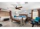 Spacious main bedroom with ceiling fan, exercise equipment, carpet, and natural wood furniture at 4321 E Morenci Rd, San Tan Valley, AZ 85143