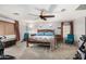 Spacious main bedroom with ceiling fan, exercise equipment, carpet, and natural wood furniture at 4321 E Morenci Rd, San Tan Valley, AZ 85143