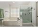 A modern bathroom with soaking tub and glass shower offers a relaxing spa-like experience at 453 E Baylor Ln, Gilbert, AZ 85296