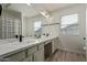 A bathroom features a dual sink vanity with updated fixtures and a shower tub at 453 E Baylor Ln, Gilbert, AZ 85296