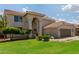 Spacious two-story home featuring a landscaped yard, archway entrance, and a two-car garage at 453 E Baylor Ln, Gilbert, AZ 85296