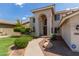 Inviting home featuring a covered entrance with grand archway and desert landscaping with stone at 453 E Baylor Ln, Gilbert, AZ 85296