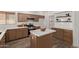 Modern kitchen featuring stainless steel appliances, wood cabinets, and a center island at 453 E Baylor Ln, Gilbert, AZ 85296