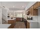 Open concept kitchen with a center island, modern appliances, and hardwood floors at 453 E Baylor Ln, Gilbert, AZ 85296