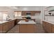 Updated kitchen with an island, stainless appliances, modern fixtures and wood grain flooring at 453 E Baylor Ln, Gilbert, AZ 85296