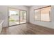 Bright sun room with hardwood floors and sliding glass doors to patio at 453 E Baylor Ln, Gilbert, AZ 85296