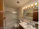 Bathroom featuring a shower-tub combo, tiled walls, and vanity at 4602 N 50Th Ave, Phoenix, AZ 85031