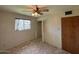Bedroom with a ceiling fan, a window, and a closet with open doors at 4602 N 50Th Ave, Phoenix, AZ 85031