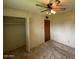 Bedroom featuring a ceiling fan, closet, and warm lighting for relaxation at 4602 N 50Th Ave, Phoenix, AZ 85031