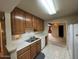 Kitchen showcasing ample wooden cabinets and white countertops, open to the living area at 4602 N 50Th Ave, Phoenix, AZ 85031