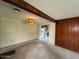 The room has a vintage light fixture and wood paneled walls, connecting to the kitchen at 4602 N 50Th Ave, Phoenix, AZ 85031