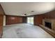 Expansive living room with wood paneling, fireplace, and sliding doors to the yard at 4602 N 50Th Ave, Phoenix, AZ 85031