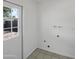 Bright utility room with hookups ready, and exterior door with window to allow in natural light at 4607 W Becker Ln, Glendale, AZ 85304