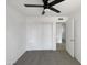 Carpeted bedroom featuring closet with sliding doors and a ceiling fan at 4607 W Becker Ln, Glendale, AZ 85304