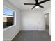 Clean bedroom with carpet, a ceiling fan, and a bright window providing ample light at 4607 W Becker Ln, Glendale, AZ 85304