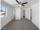 Large bedroom with a ceiling fan and carpeted floor leading to multiple doorways at 4607 W Becker Ln, Glendale, AZ 85304