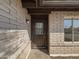 Front door of a brick home with a dark framed glass window at 4607 W Becker Ln, Glendale, AZ 85304