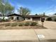 Charming single-story home with desert landscaping, a brown roof, and a spacious driveway at 4607 W Becker Ln, Glendale, AZ 85304