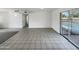 Bright living room featuring tile floors and sliding doors to a refreshing pool at 4607 W Becker Ln, Glendale, AZ 85304