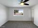 Clean bedroom featuring carpeted floors and a window showcasing the outside swimming pool at 4607 W Becker Ln, Glendale, AZ 85304