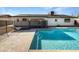 Backyard featuring a sparkling blue pool, patio area, and secure pool fencing at 4607 W Becker Ln, Glendale, AZ 85304