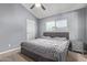 Bedroom with vaulted ceiling, fan, window and gray walls, carpet, bed, and side tables at 520 N Stapley Dr # 256, Mesa, AZ 85203